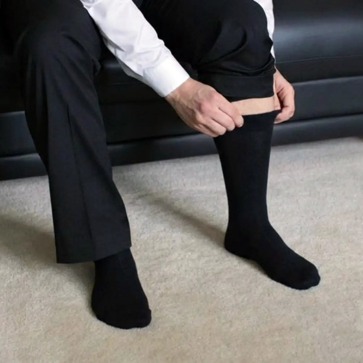 Un homme enfile des chaussettes noires sans élastiques